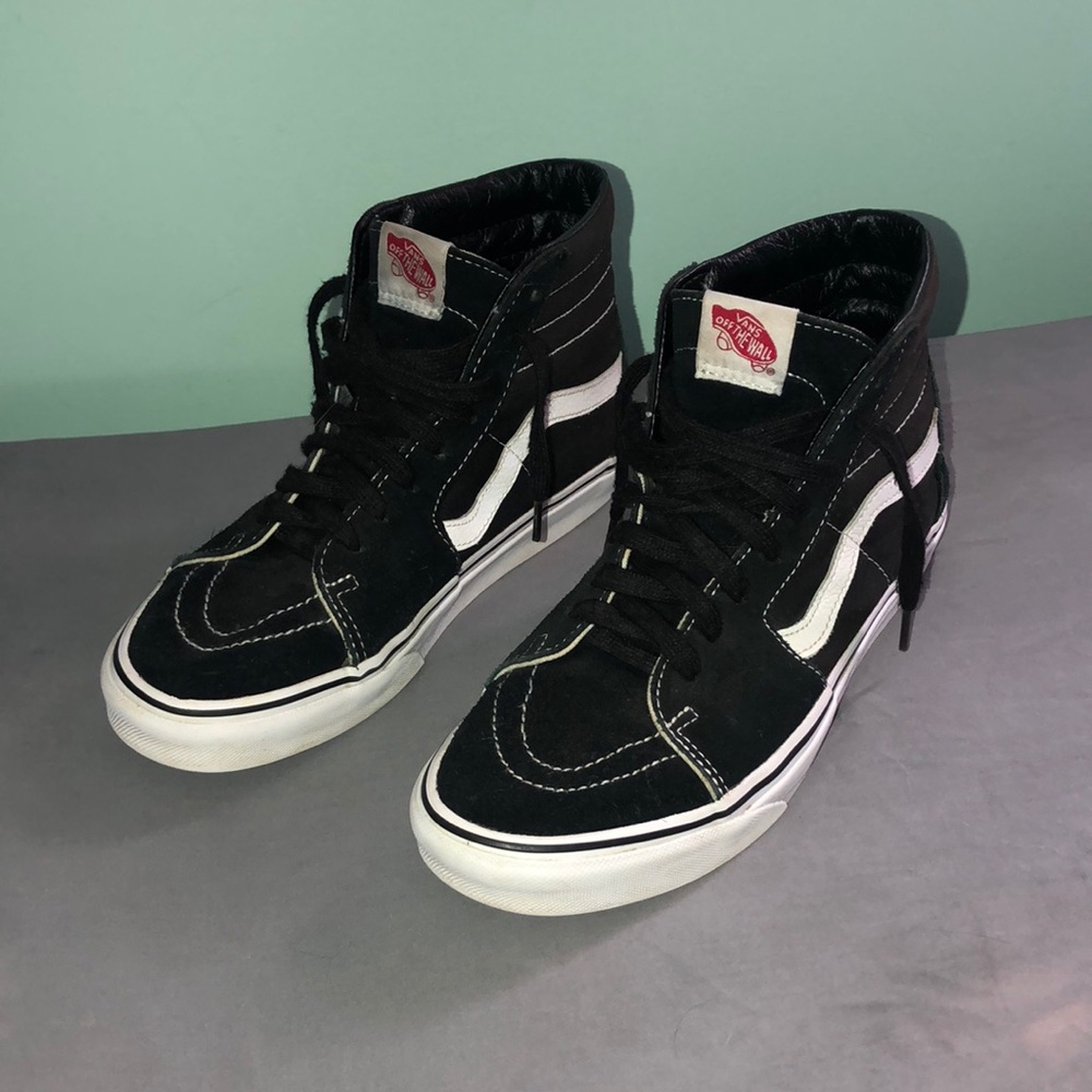 Black and white high top Vans